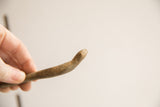 Handmade texture and aged patina on the head of a vintage snake figurine.