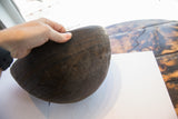 Incised geometric patterns on the aged, dark brown African hand carved wooden bowl.