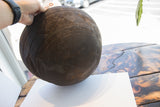 Close-up of incised geometric patterns and rich dark patina on antique African wooden bowl.