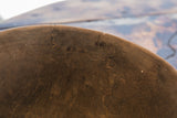 Antique African bowl's dark brown aged wood texture with visible cracks.