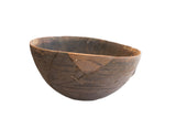 Antique African hand carved wooden bowl with a dark patina, incised details, and storied repairs.