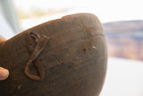 Aged leather repair and hand-carved incised texture on an antique wooden bowl.