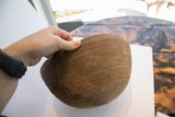 Incised geometric patterns and visible age crack on the antique African carved wooden bowl.