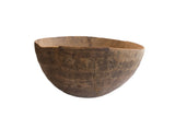 Antique African hand carved wooden bowl, dark brown, featuring visible cracks and unique repairs.