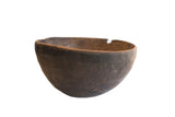 Antique hand carved African wooden bowl, deep brown with textured surface, storied rim repair.