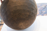 Textured dark wood surface of the antique hand-carved African bowl with subtle variations.