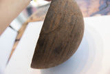 Detail of antique African wooden bowl, showcasing incised lines and visible metal repairs.