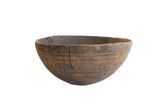 Antique hand-carved African wooden bowl with incised patterns and a storied repair.