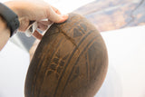 Detail of a historic, stitched repair over a crack on the hand-carved bowl.