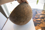 Visible texture and incised details on the aged Nupe hand carved wooden bowl.