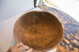 African hand carved wooden bowl interior, highlighting incised repair and natural wood patina.