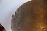 Aged texture and deep brown color of antique African wooden bowl with cracks.