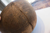 Antique African wooden bowl with incised patterns and wavy metal repairs over a crack.