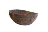 Antique African hand-carved wooden bowl, dark brown with incised lines and prominent zigzag repairs.