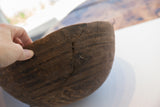 Dark wood antique African bowl with prominent crack and storied zigzag metal repairs.
