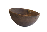 Antique African hand carved wooden bowl with rich patina, incised design, and metal repair, 12 inches.