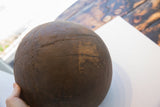 Aged surface detail showing old cracks and metal staple repairs on the antique African bowl.