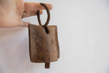 African iron bell's weathered clapper with rich, rustic patina.
