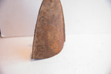 Patina and rustic texture of the handmade iron bell's side.