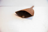 Textured, rusted iron surface of the vintage African Yoruba bell with interior clapper.