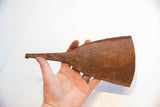 Hand-forged African Yoruba iron bell showing its textured, rust patina.