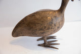 Angled view of the vintage African bird's body, highlighting its textured, aged patina.