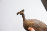 Profile of a vintage African bird casting showing its distinctive head and slender neck.