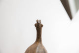 Upward view of the sculpted head and neck on the vintage African bird casting.