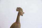 Side profile of the vintage African bird casting's head and textured neck.