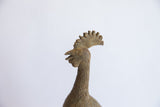 Profile view of the vintage bird casting's head showing its textured crest and patina.