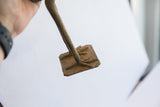 Close-up of the rustic, patinated base of a vintage African bird casting.