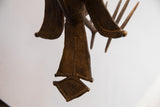 Underside detail of the vintage African casting's fanned, textured tail.