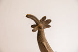 Angled close-up of the vintage bird casting's fanned crest and curved beak.
