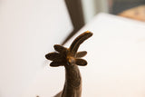 Top-down view of the vintage African bird casting's head showing its five-pointed crest.