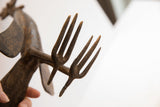 Rustic texture on the four-pronged details of a vintage African bird casting.