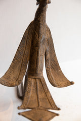 Carved geometric details on the back and spread wings of the vintage African bird casting.