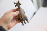 The hand-carved spine and rustic texture of the vintage African antelope sculpture.