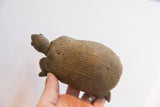 Top view of a vintage African tortoise sculpture showing its hand-carved geometric shell.