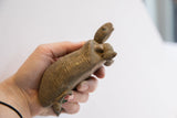 Vintage African tortoise sculpture held in hand to demonstrate its scale.