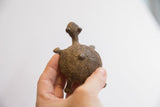 Back view of a bronze-toned vintage African tortoise sculpture with textured, handmade shell.