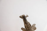 Overhead detail of the handmade alligator sculpture's head with a fish in its mouth.
