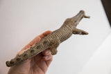 Vintage carved alligator sculpture held in hand to show its scale and handmade texture.