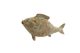 Vintage African fish casting with hand-etched spiral patterns and a weathered green patina.
