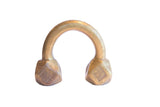 Antique African U-shaped cuff bracelet with geometric etched base ends and a warm patina.