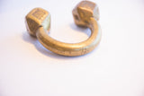 Angled detail of the antique African cuff bracelet's warm, aged metal patina.