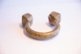Front view of the antique African cuff bracelet highlighting its U-shape and patina.