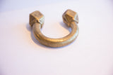 Antique African cuff bracelet showing its curved opening and faceted geometric ends.