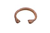 Antique African copper cuff bracelet with etched geometric details and flared square ends.