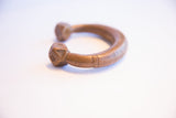 Incised geometric patterns on the faceted copper base of an antique African cuff.