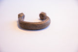Aged patina and hand-etched geometric patterns on an antique African cuff.